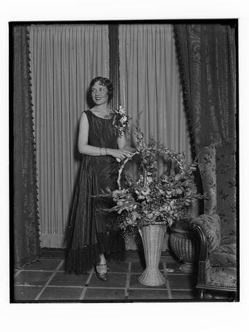 Woman with a corsage and flowers at the Club Casa del Mar, Santa Monica, California