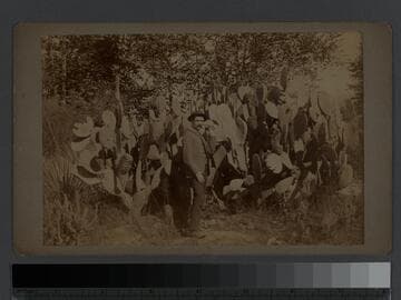 Photo of H.F. Rile, photographer, with prickly pear cactus