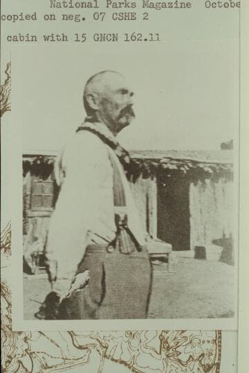 Cass Hite in front of cabin at Hite