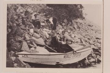 The battered "Wen" pulled up on the talus near the foot of Rapid 23, left bank.  Upper:  Don Harris, Norm Nevills, Lois Jotter.  Lower:  Bill Gibson, Gene Atkinson