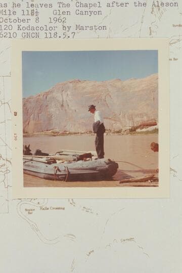 Bishop Wells steps into Ken Sleight's inflated boat as he leaves The Chapel after the Aleson wedding.  Mile 118.5, Glen Canyon