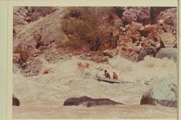 Buzz Belknap in the "Bootoo" clearing the big wave in Vulcan Rapid.  Dock Marston is passenger
