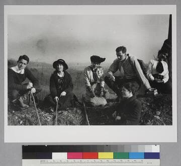 Edwin Powell Hubble with five unidentified companions, seated with walking sticks outdoors