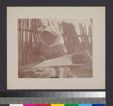 Woman making cradle board