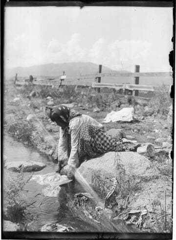 Washoe woman washing clothes in the river near Sparks, Nevada, 1912