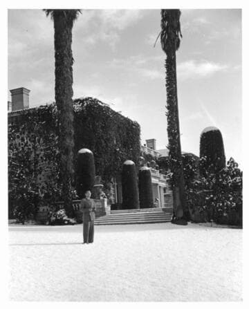 Irwin Morrkisch in front of the Huntington residence after snowfall, January 11, 1949