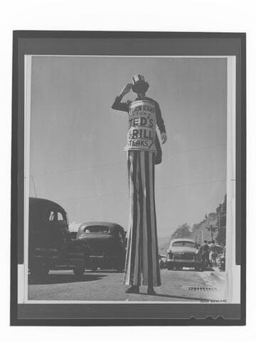 Ted's Grill advertisement on man with stilts, Santa Monica Canyon