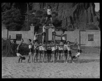 Gymnasts pose in human pyramid, Gables Beach Club, Santa Monica