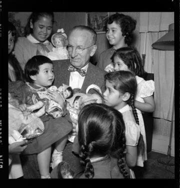Little girls receiving Christmas dolls