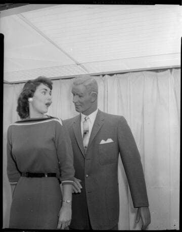 Young lady posing with store mannequin
