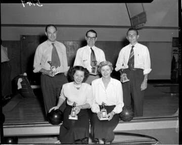 Five person bowling team with trophys