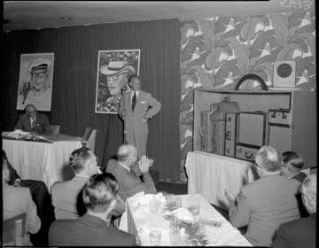 McFadden standing by retirement gift at banquet