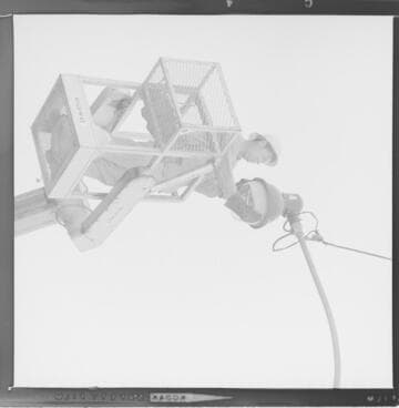 Lineman repairing broken glass street light globes