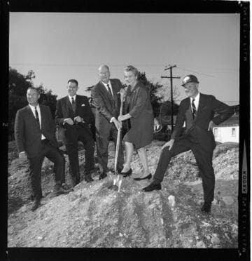 Group of men with one woman staging a ground breaking event for a Gold Medallion Home