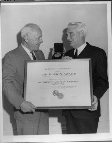 Edison Chairman of the Board Harold Quinton (left) accepts the Thomas A