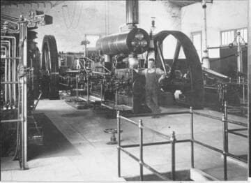 Plant Engineer Milton Nicholson stands by the Corliss engine at the Oxnard Steam Plant, about 1910