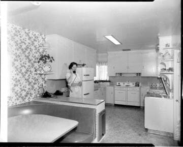 Woman talking on phone in kitchen