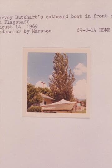 Harvey Butchart's outboard boat in front of his house in Flagstaff